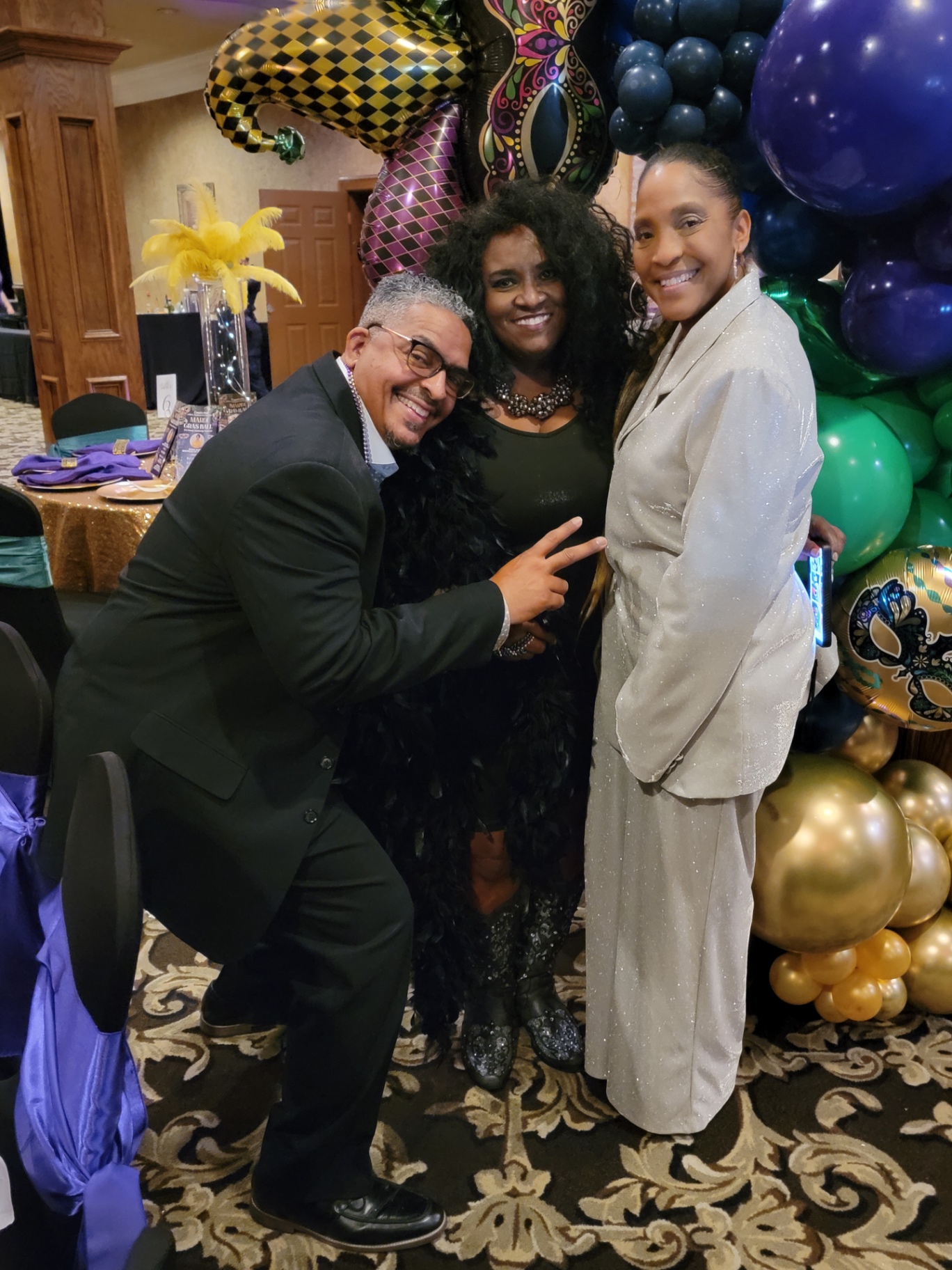 Guests posing at the Mardi Gras Ball