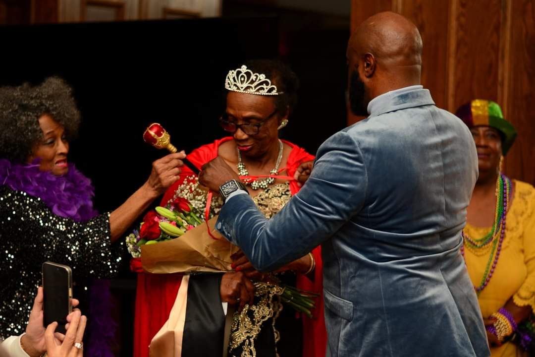 Mardi Gras Queen receiving the scepter