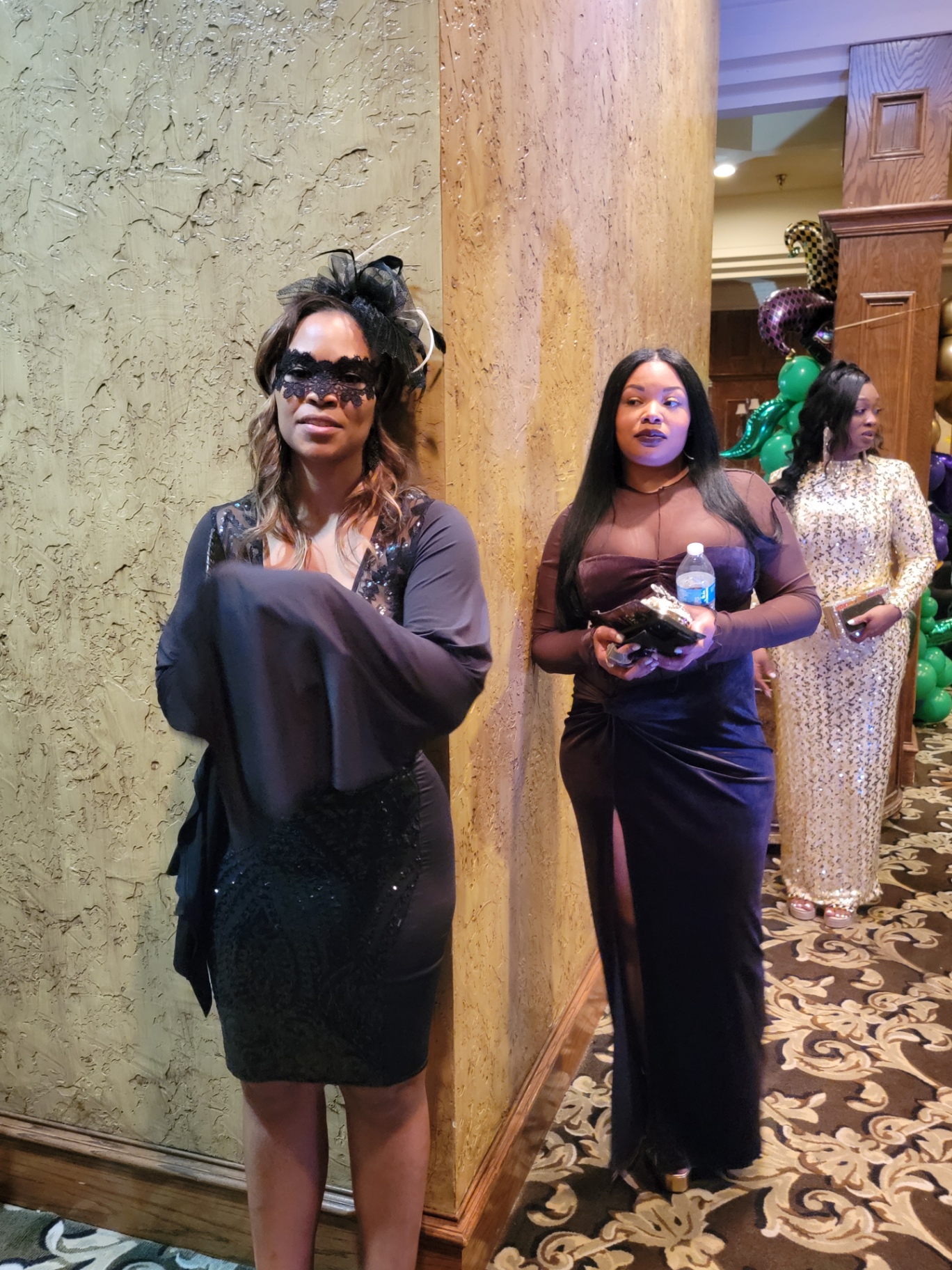 Masquerade guests in the hallway